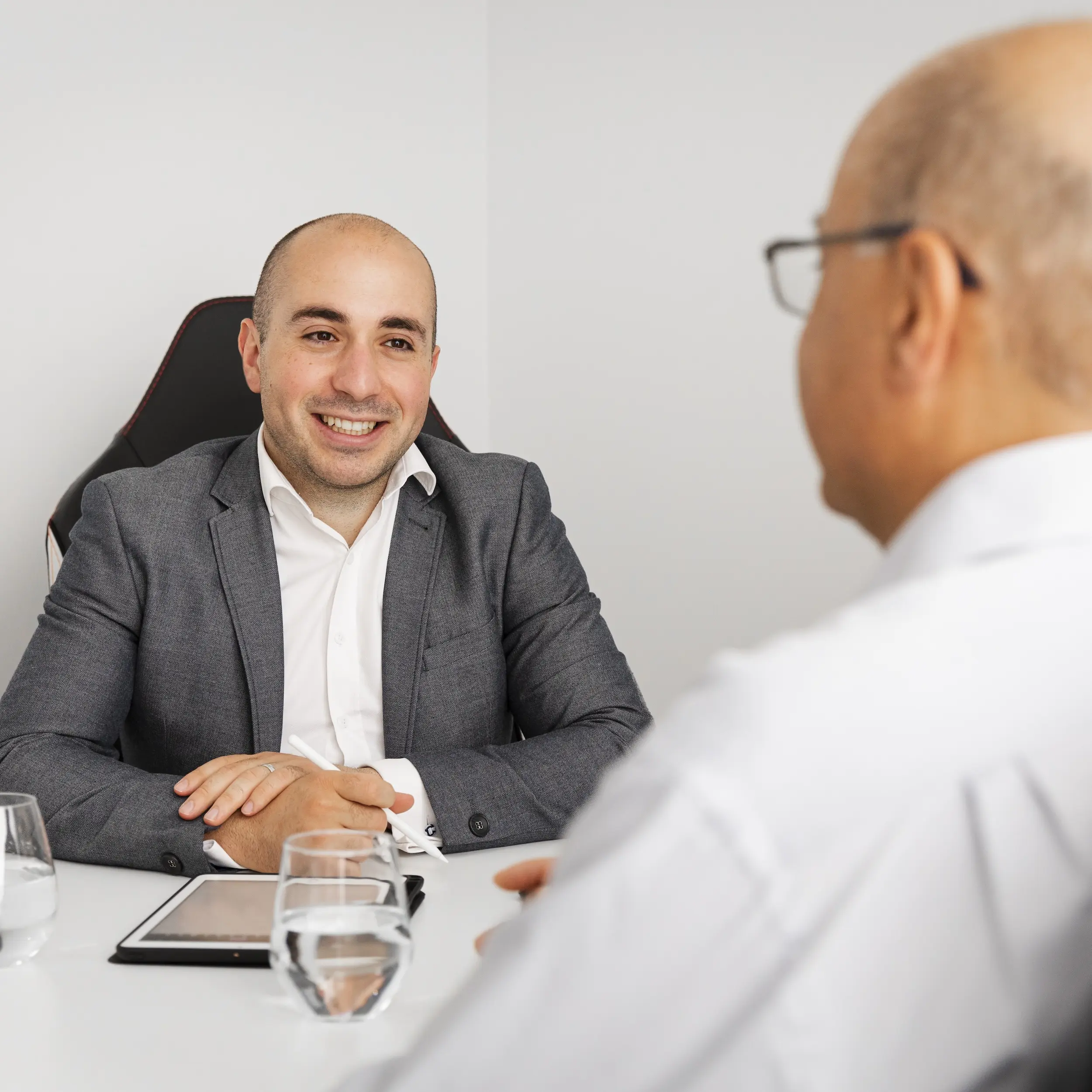 Robert Daniele speaking with a client in a meeting.